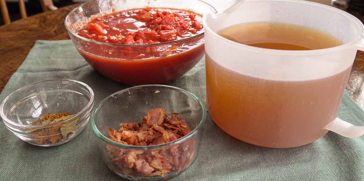 bowls of chopped tomatoes, seasonings, vegetable broth, cooked bacon.