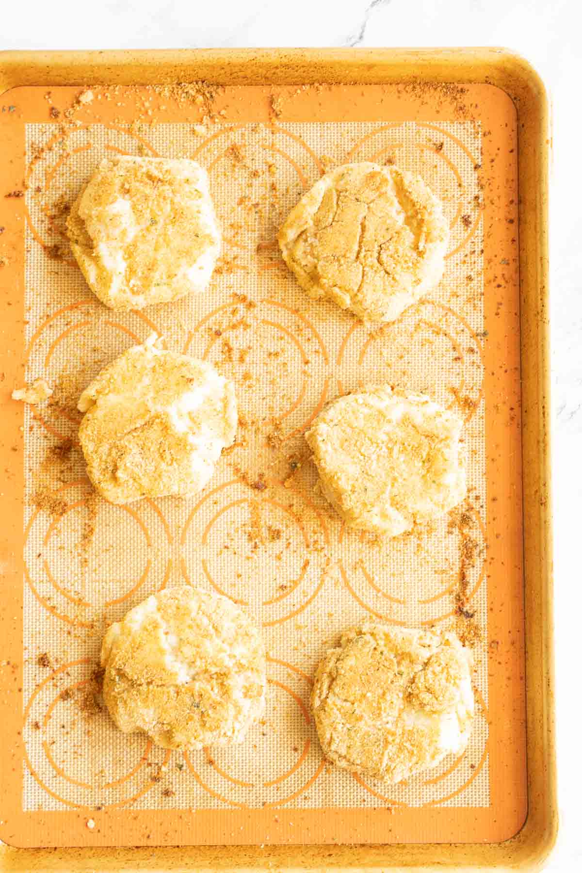 Baked Mashed potato balls on baking sheet.