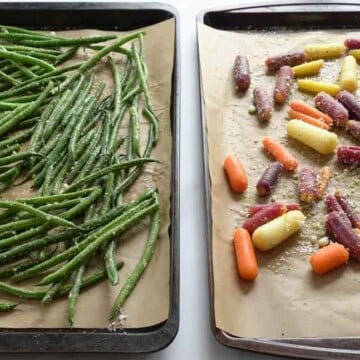 Roasted string beans and carrots on baking sheet