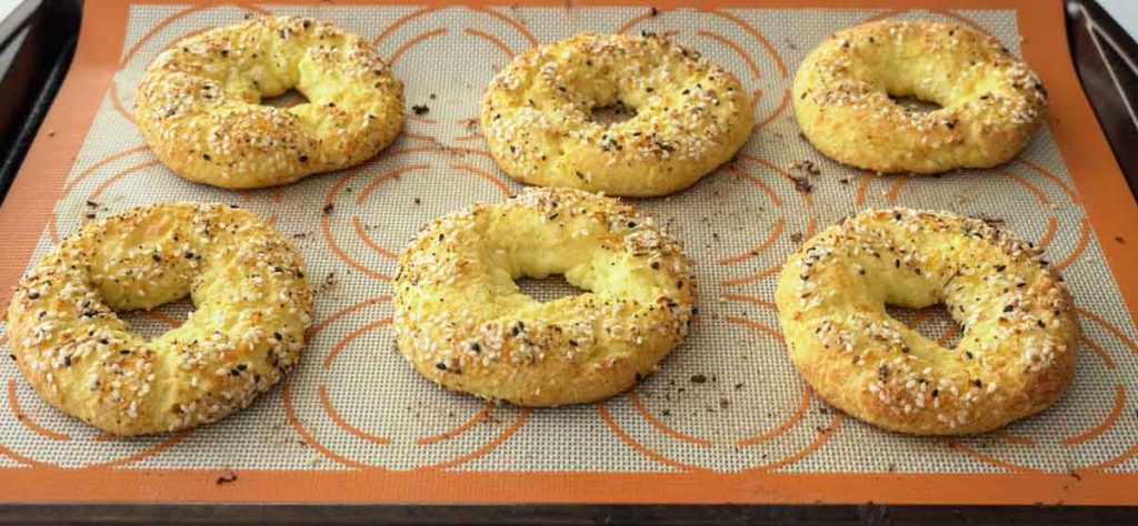 Baked low carb breakfast bagels on silicone mat and baking sheet
