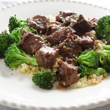 Instant Pot Beef and Broccoli over Cauliflower rice on white plate