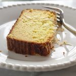 slice of low carb coconut pound cake on white plate