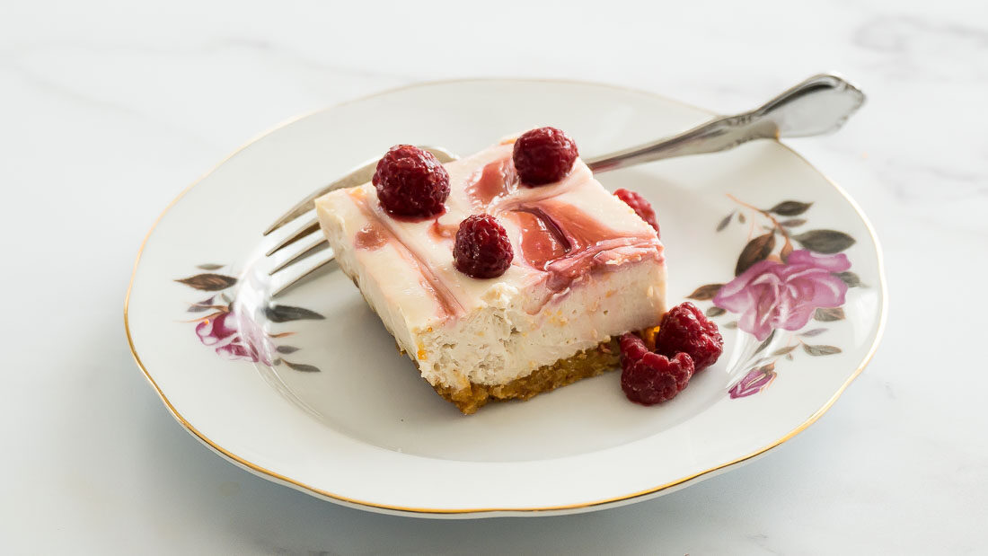low carb raspberry cheesecake on white dessert plate.