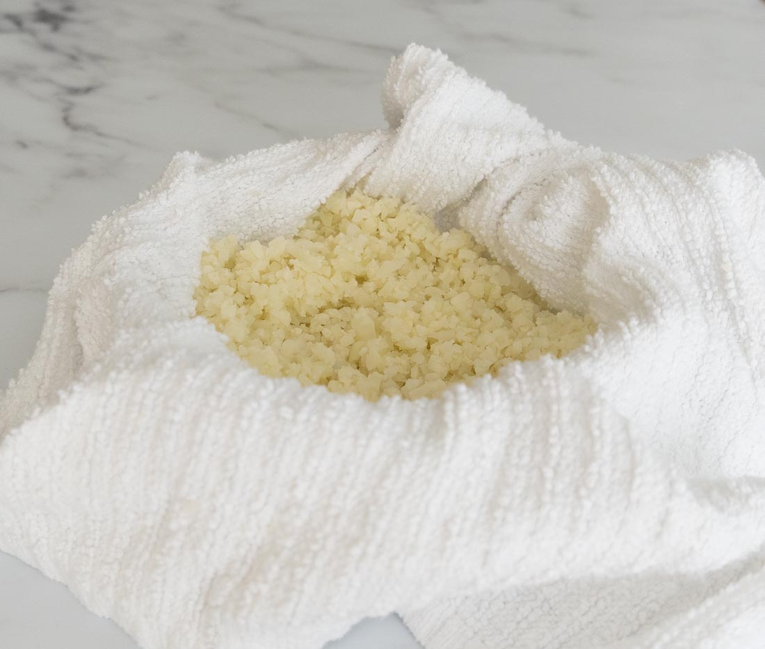 cauliflower rice in white kitchen towel. 