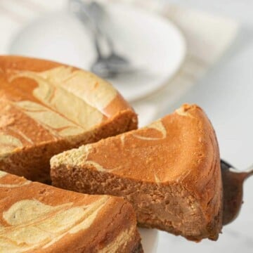 keto swirled pumpkin cheesecake on cake platter