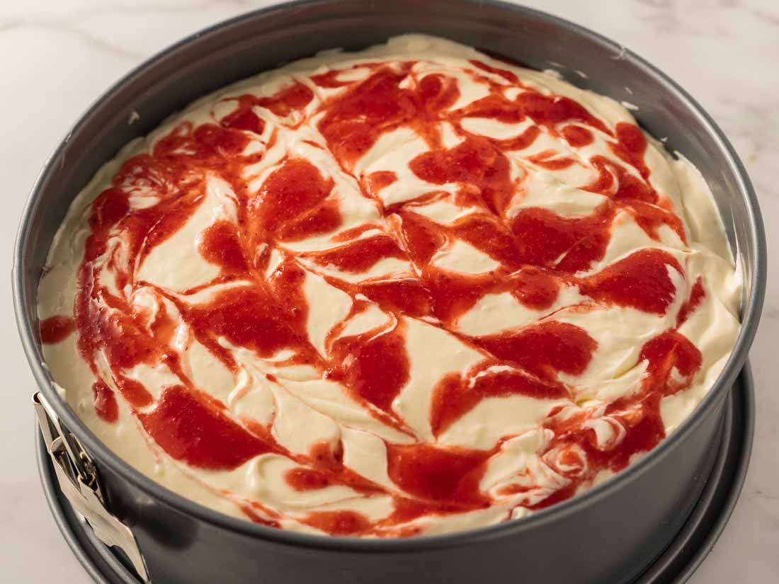 keto strawberry cheesecake swirled in a springform pan