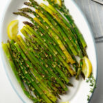 asparagus and lemon on white platter