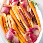carrots, red onions on white platter