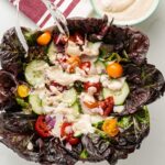 garlic dressing on red lettuce salad
