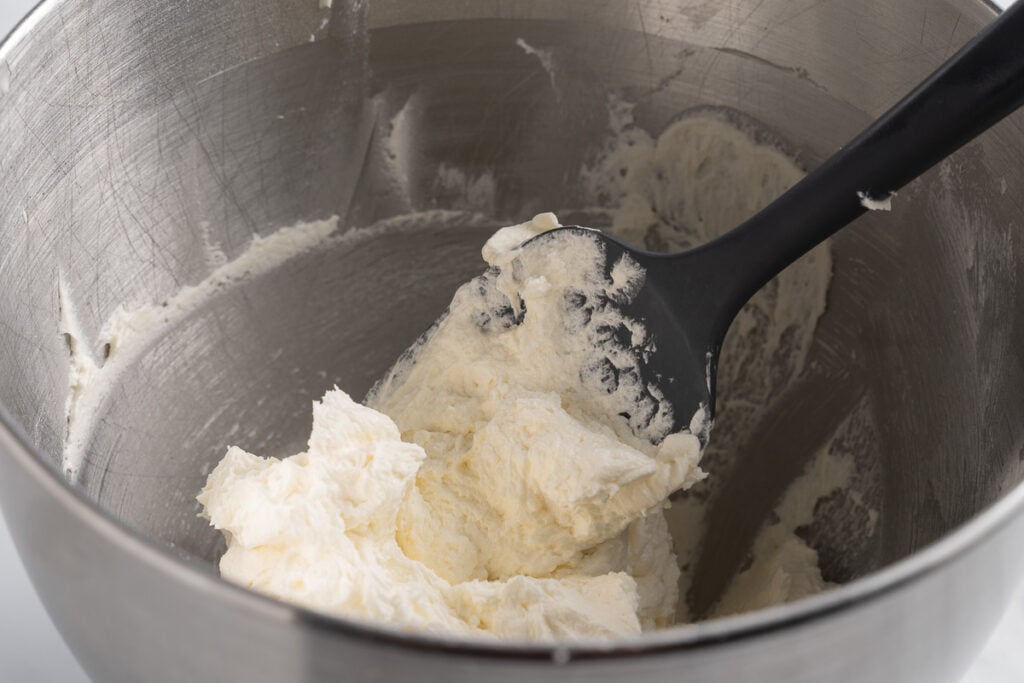 coconut buttercream in mixing bowl with spatula