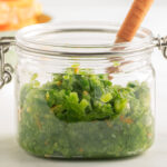 Jalapeno orange relish in glass jar with mini spoon