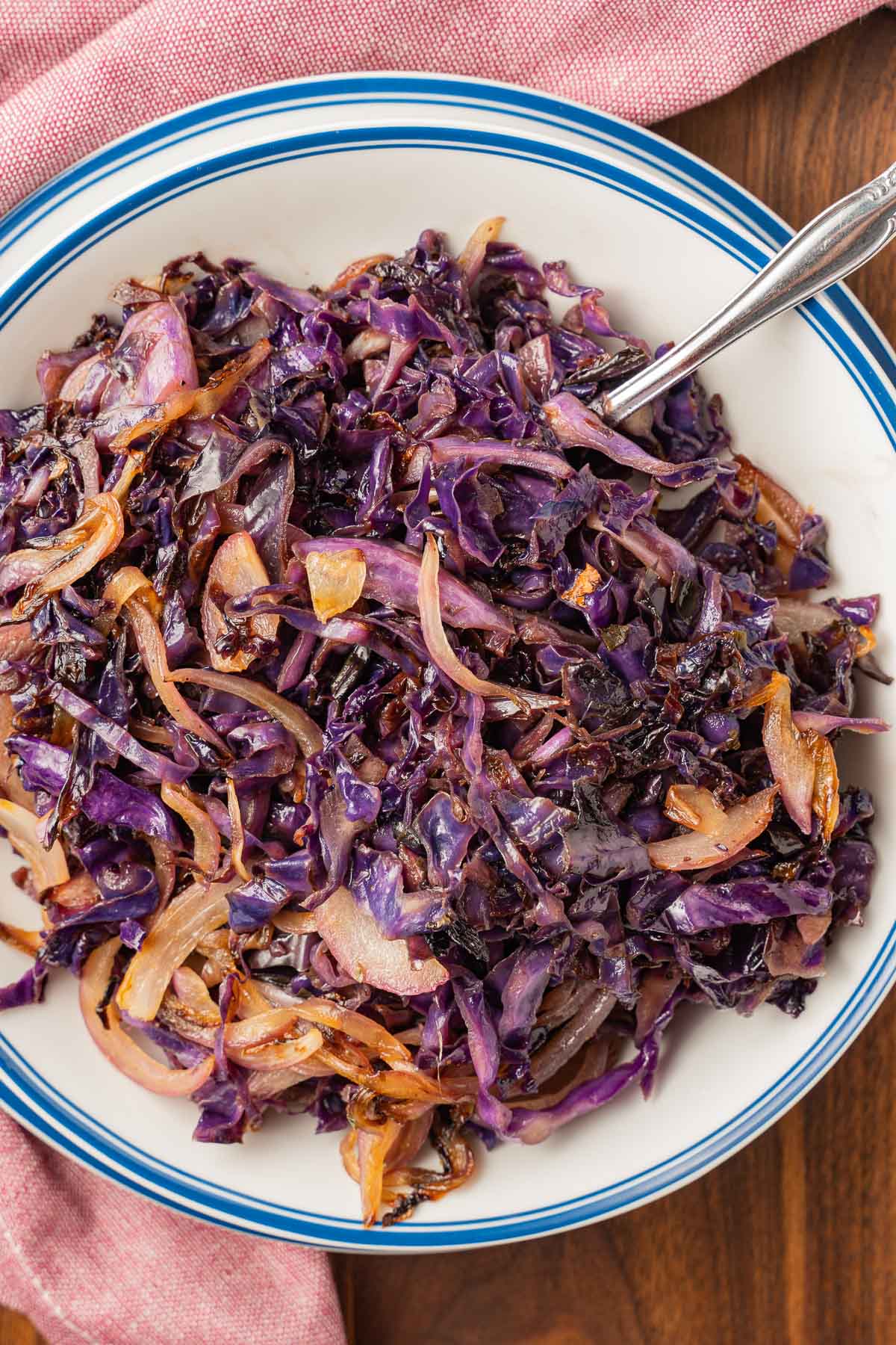 red cabbage and onions in white bowl on a wooden board