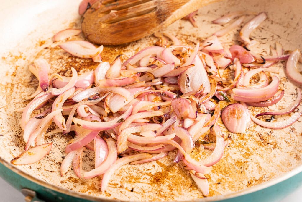 sautéed red onions in fry pan.
