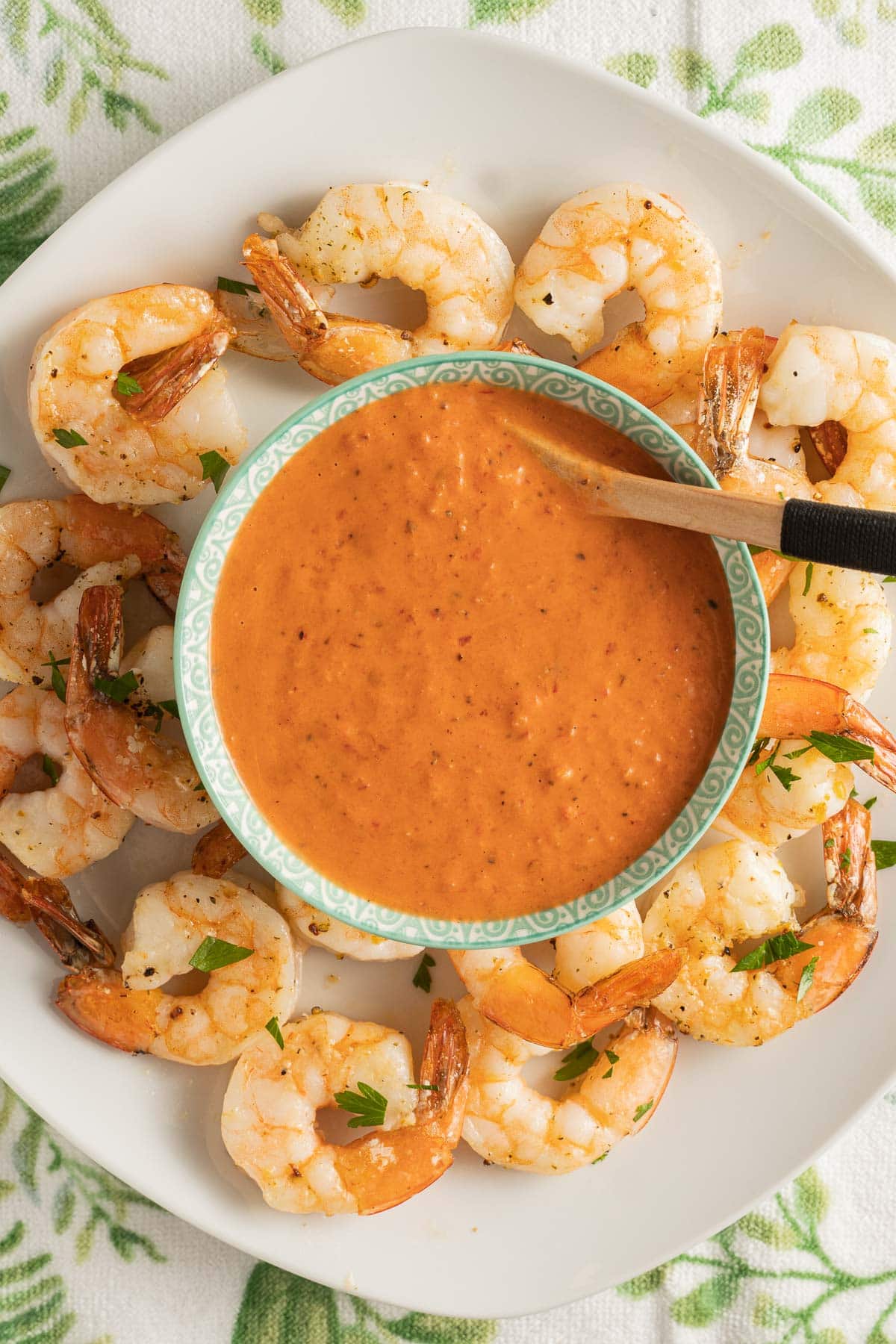 garlic shrimp on platter with baja sauce in bowl.