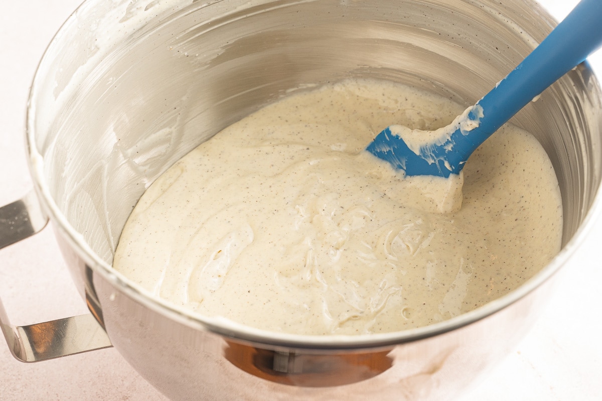 cheesecake batter in mixing bowl with spatula.