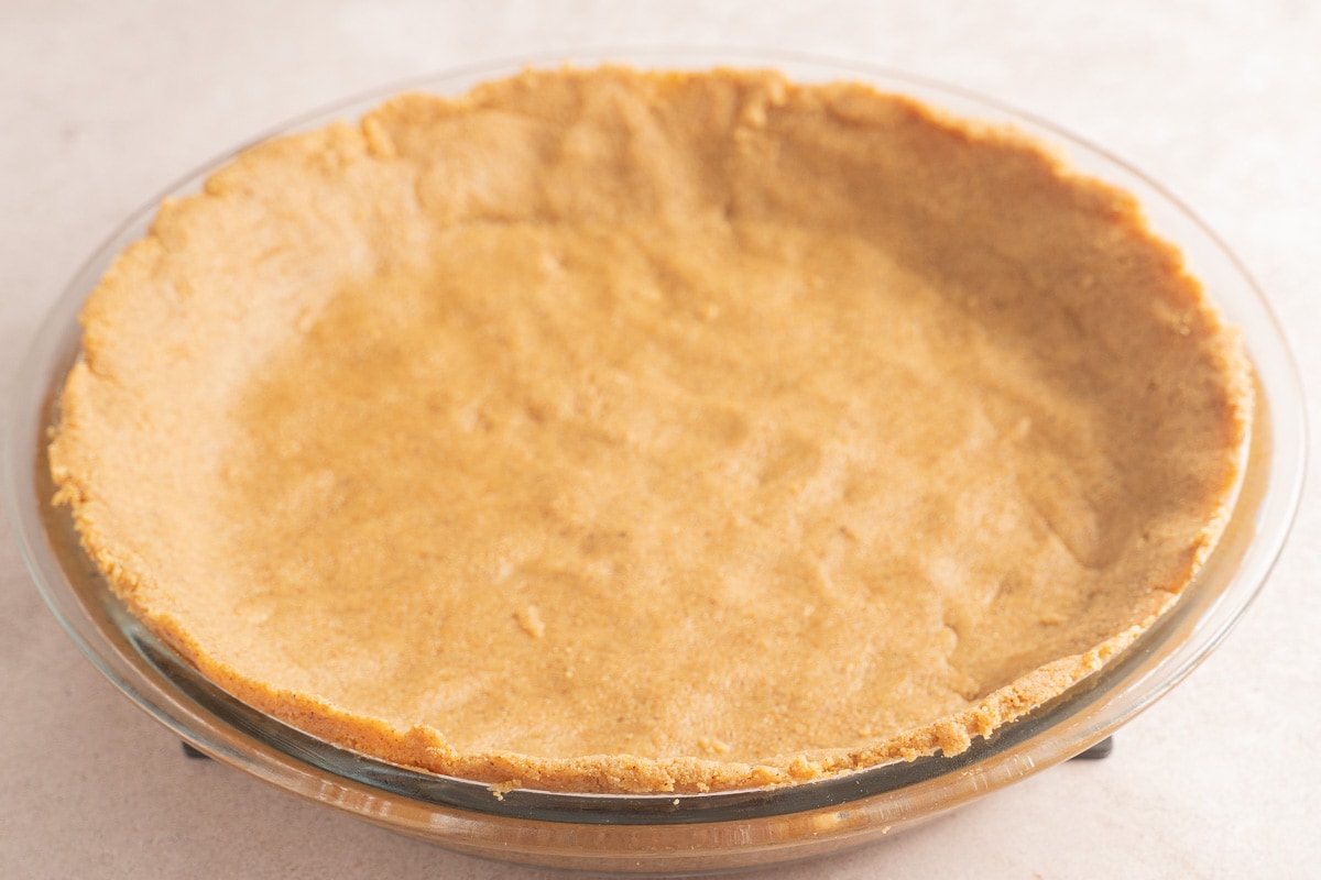 unbaked almond flour crust in pie plate.