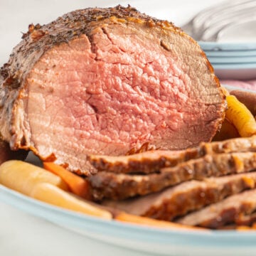 Air Fryer Garlic Roast Beef on platter with carrots.