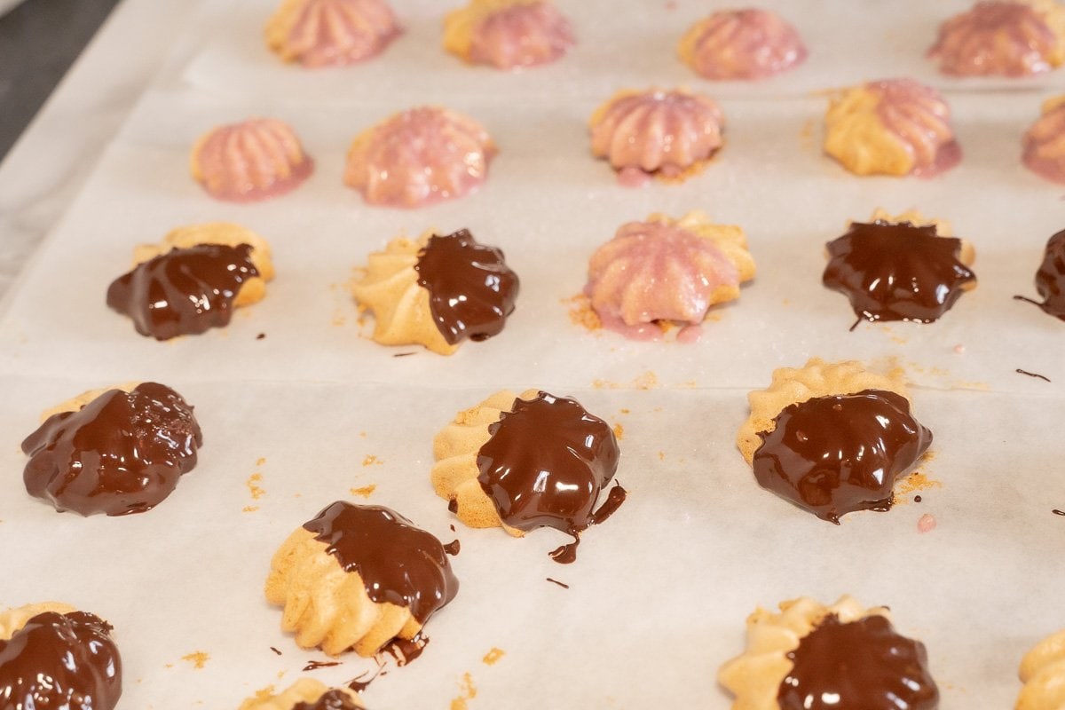 chocolate dipped meringue cookies on parchment.