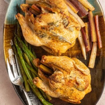 Cornish Hens on platter with vegetables.