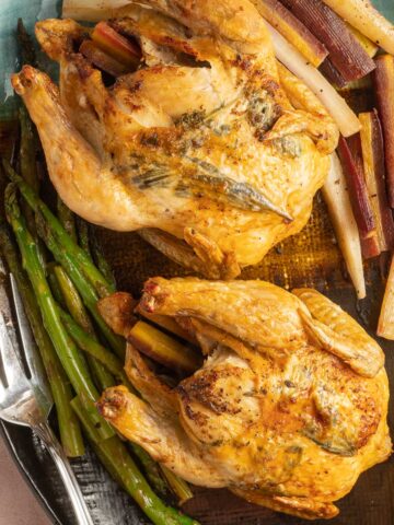 Cornish Hens on platter with vegetables.