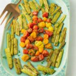 Roasted celery and cherry tomatoes on green platter.