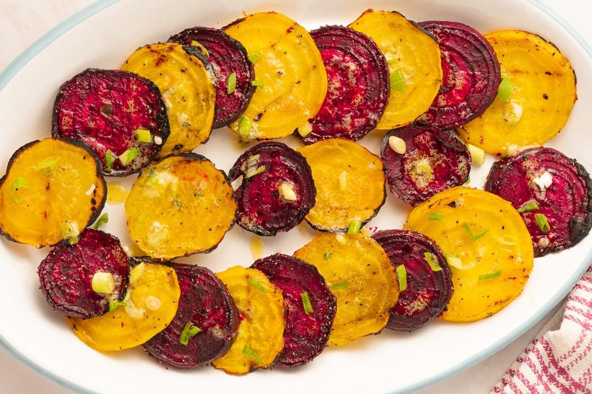 yellow and red beets on white plate.