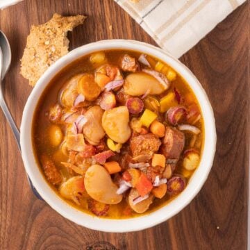 Butter bean stew in bowl on board.