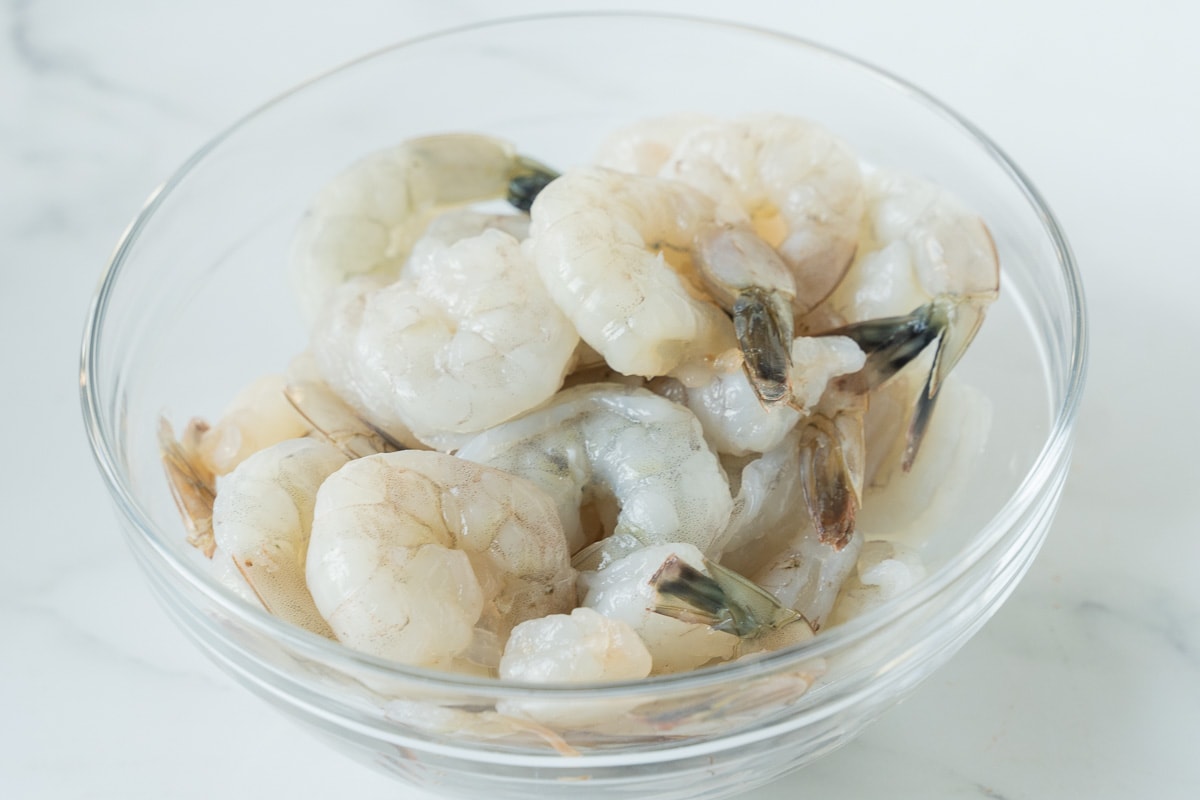 raw shrimp in glass bowl.