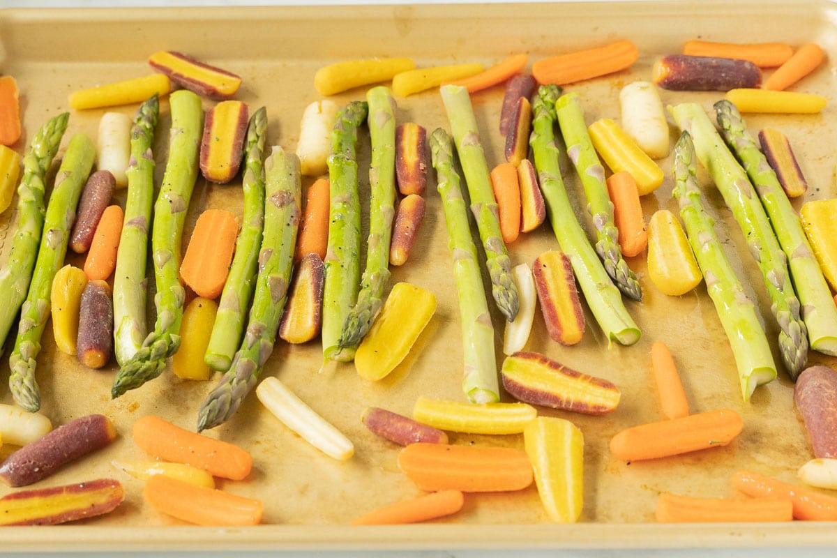 asparagus and carrots on baking sheet.