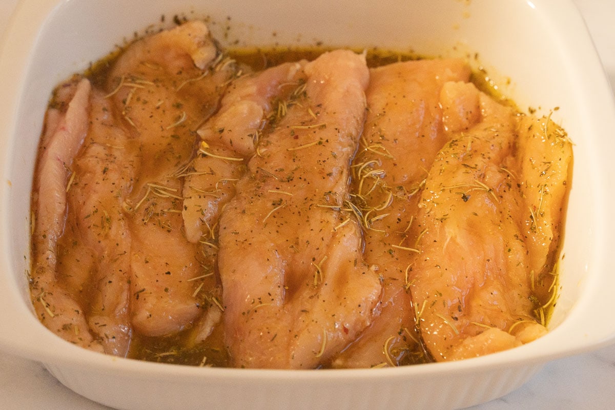 Marinated chicken breasts in bowl.
