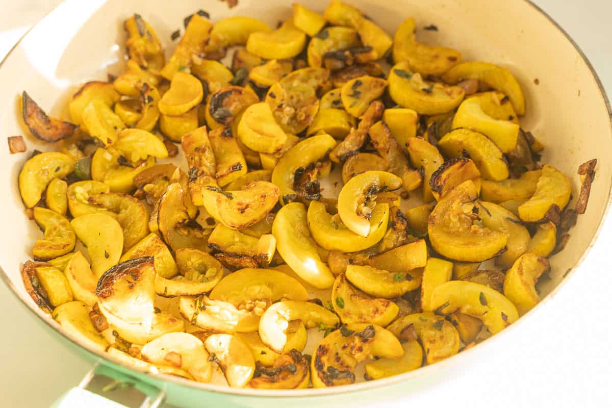 Fried yellow squash in skillet.