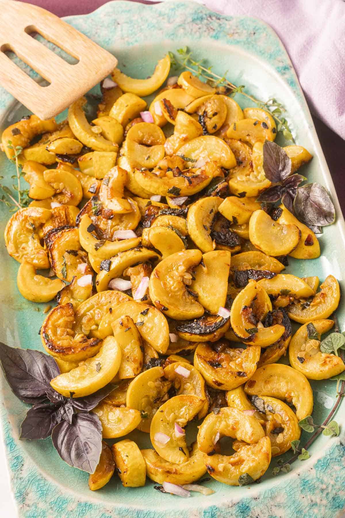 Pan Fried Yellow Squash on green platter.