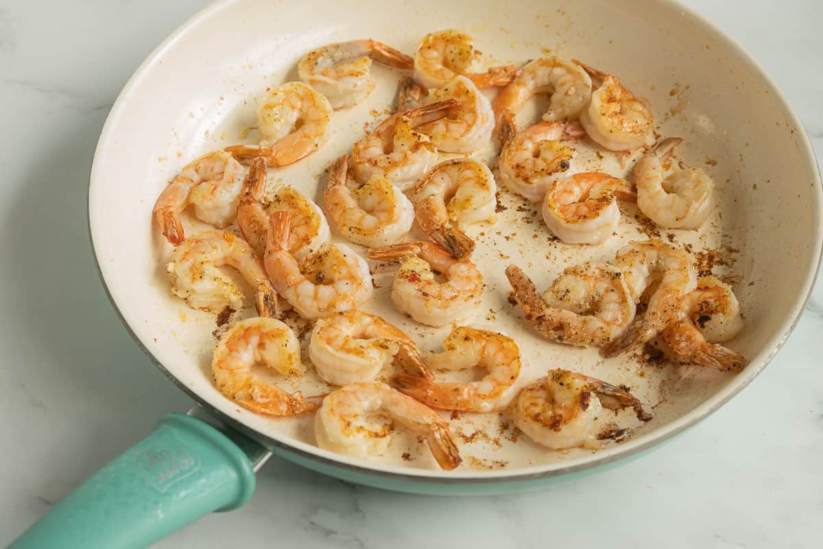 Sautéed pepper shrimp in frying pan.