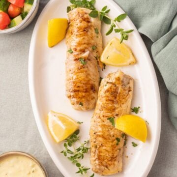 Grilled Haddock on white plate.