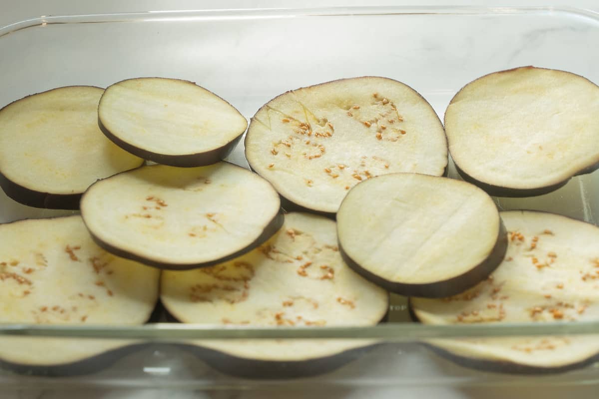 Sliced eggplant in glass dish.