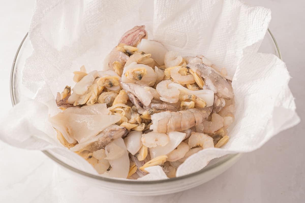 Seafood melody with paper towel in glass bowl.