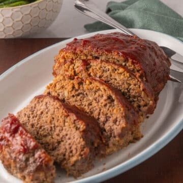 Sliced meatloaf on platter.