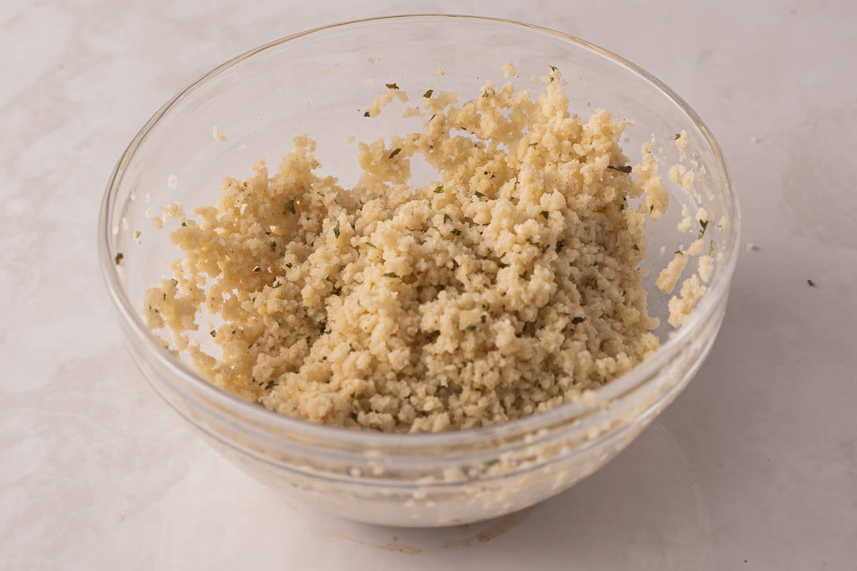 Panko combined with milk in glass bowl.