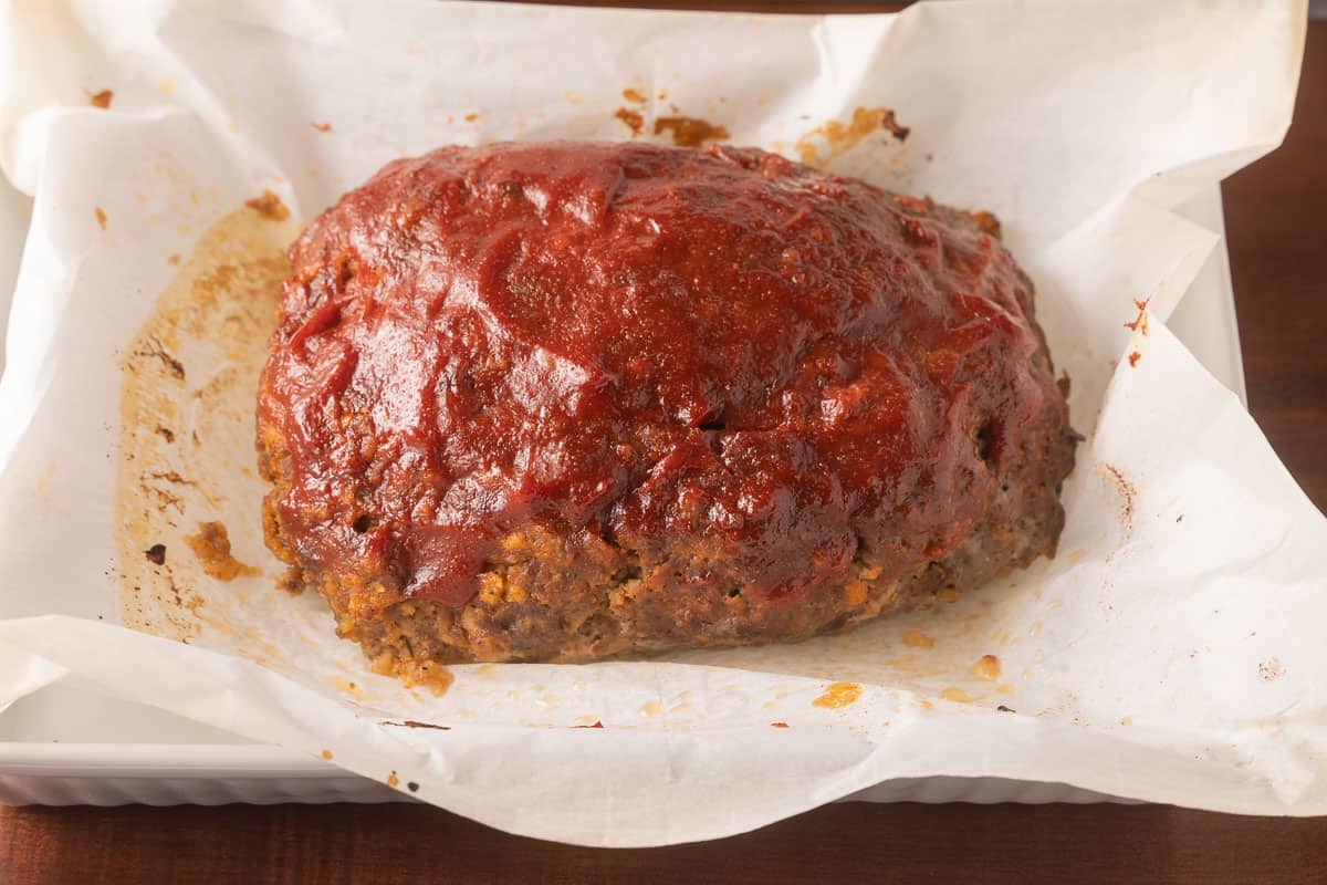 Baked Meatloaf on parchment in a casserole dish.