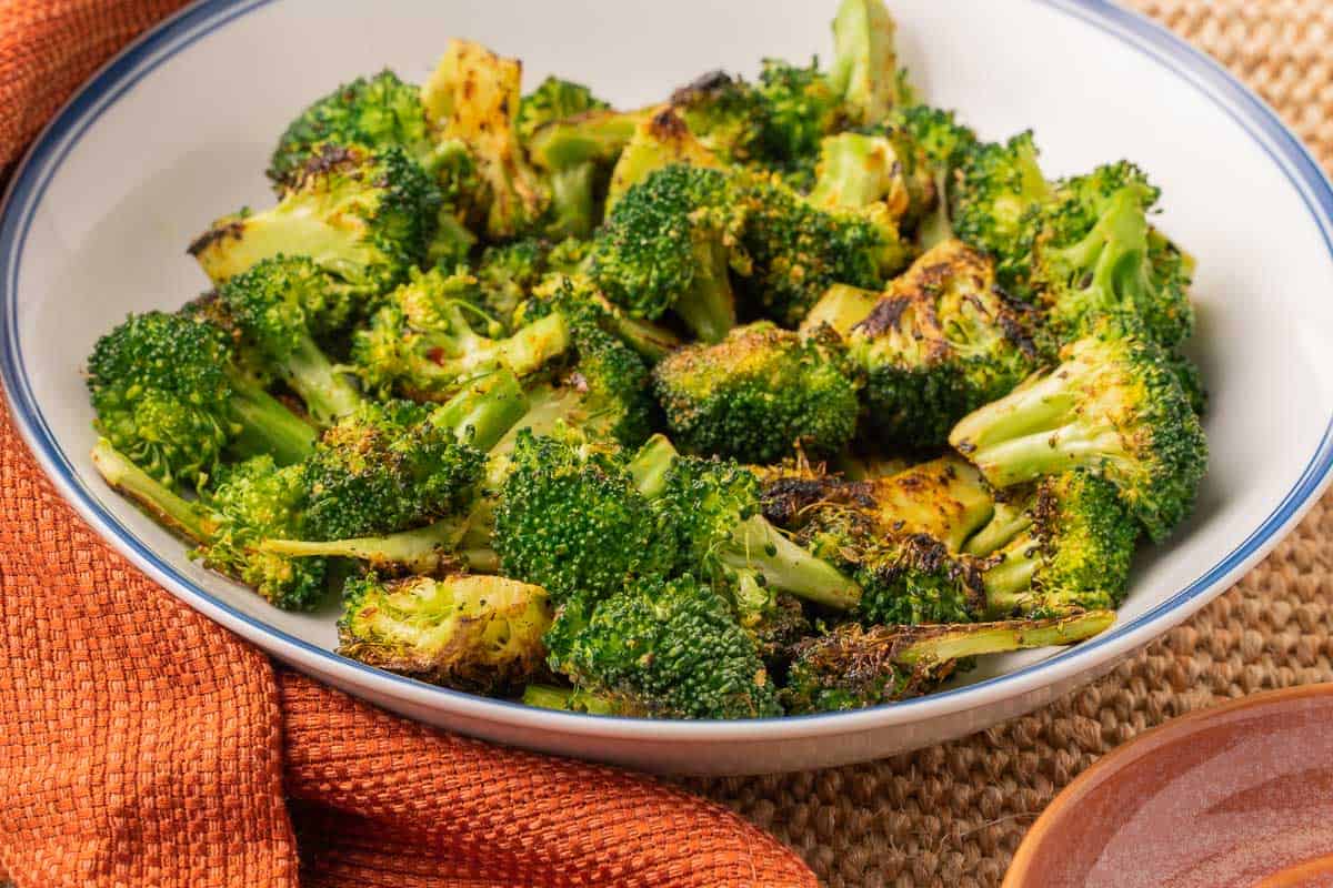 charred broccoli in white bowl.