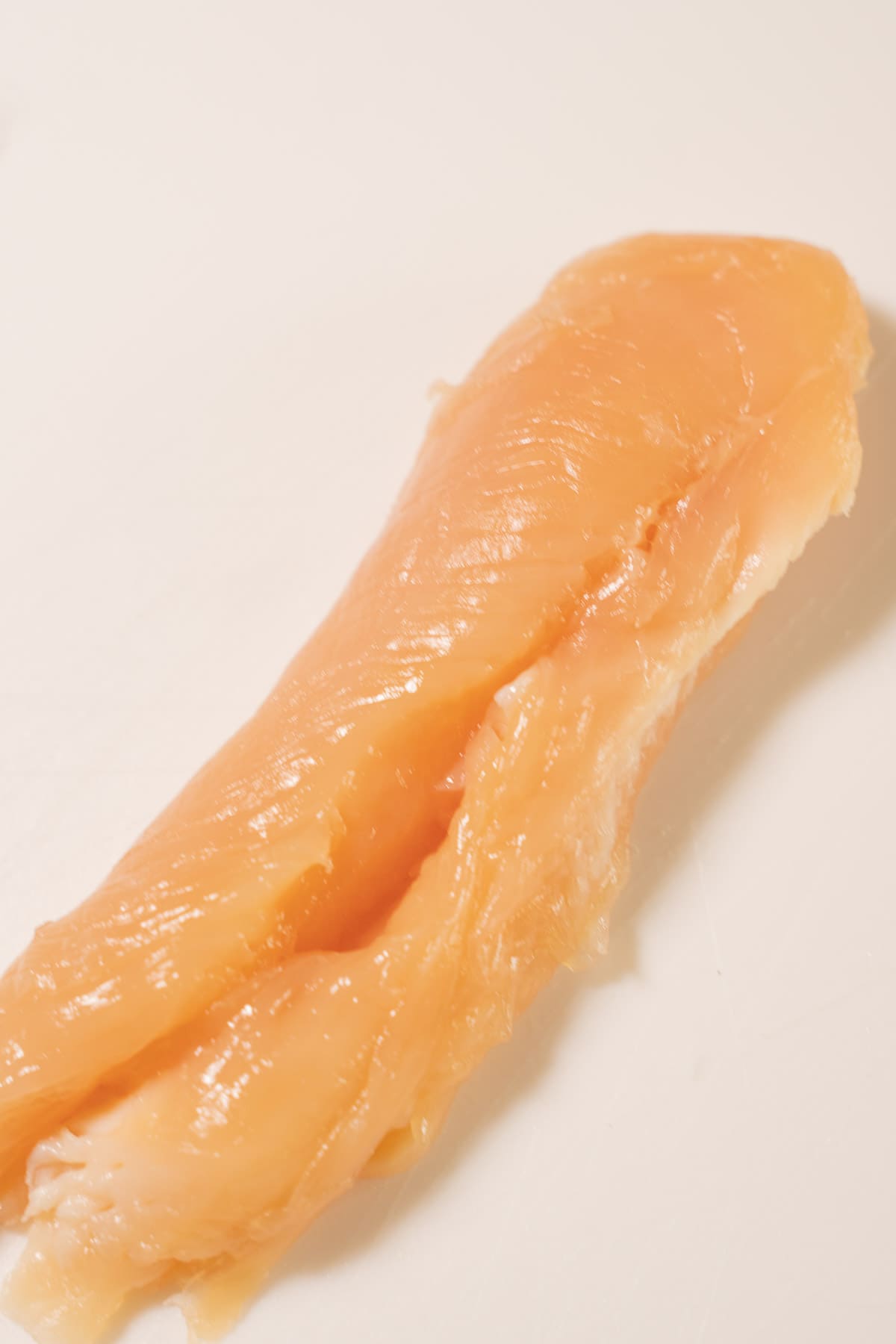 Chicken strip with tendon removed.