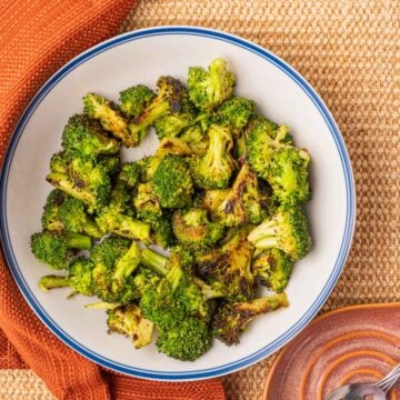 Charred Broccoli in white bowl.