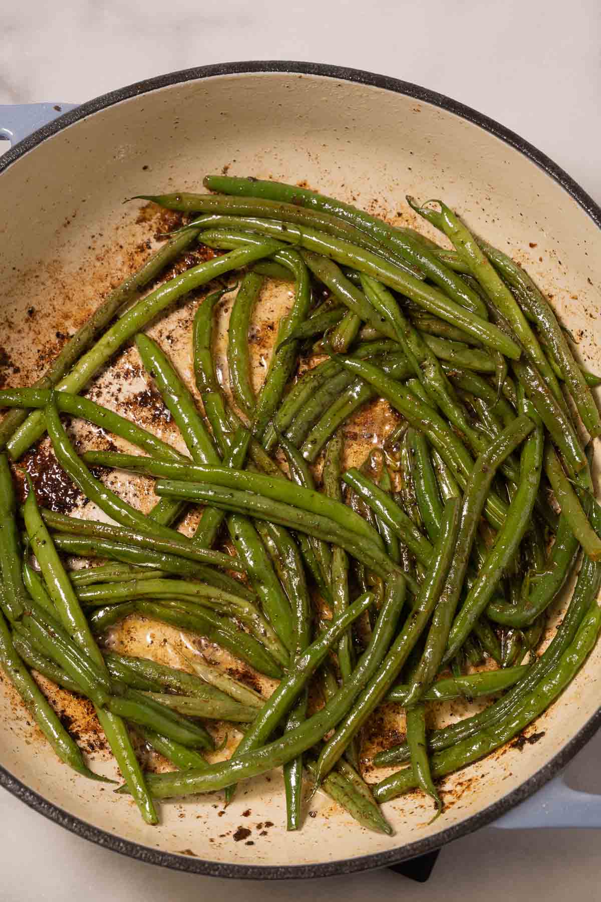 sautéed string beans in skillet.