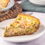 Asparagus and Ham Quiche on white plate.