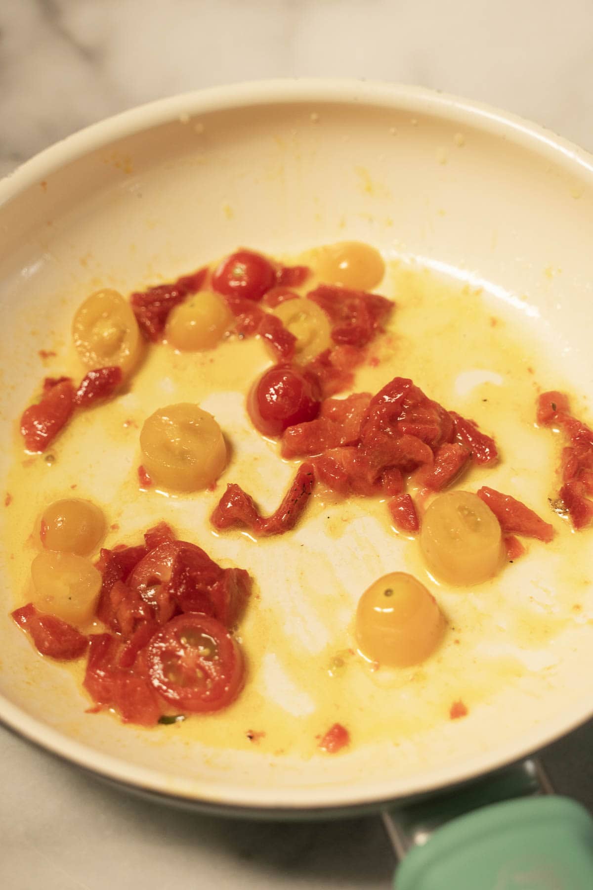 Sautéed tomatoes in skillet.