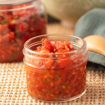 tomato and chili jam in glass jar.