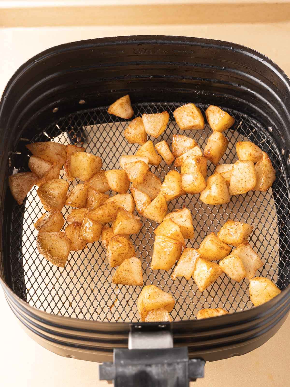 Air Fried apples in fryer basket.
