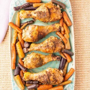 Slow Cooker Chicken Legs and Carrots on green platter.