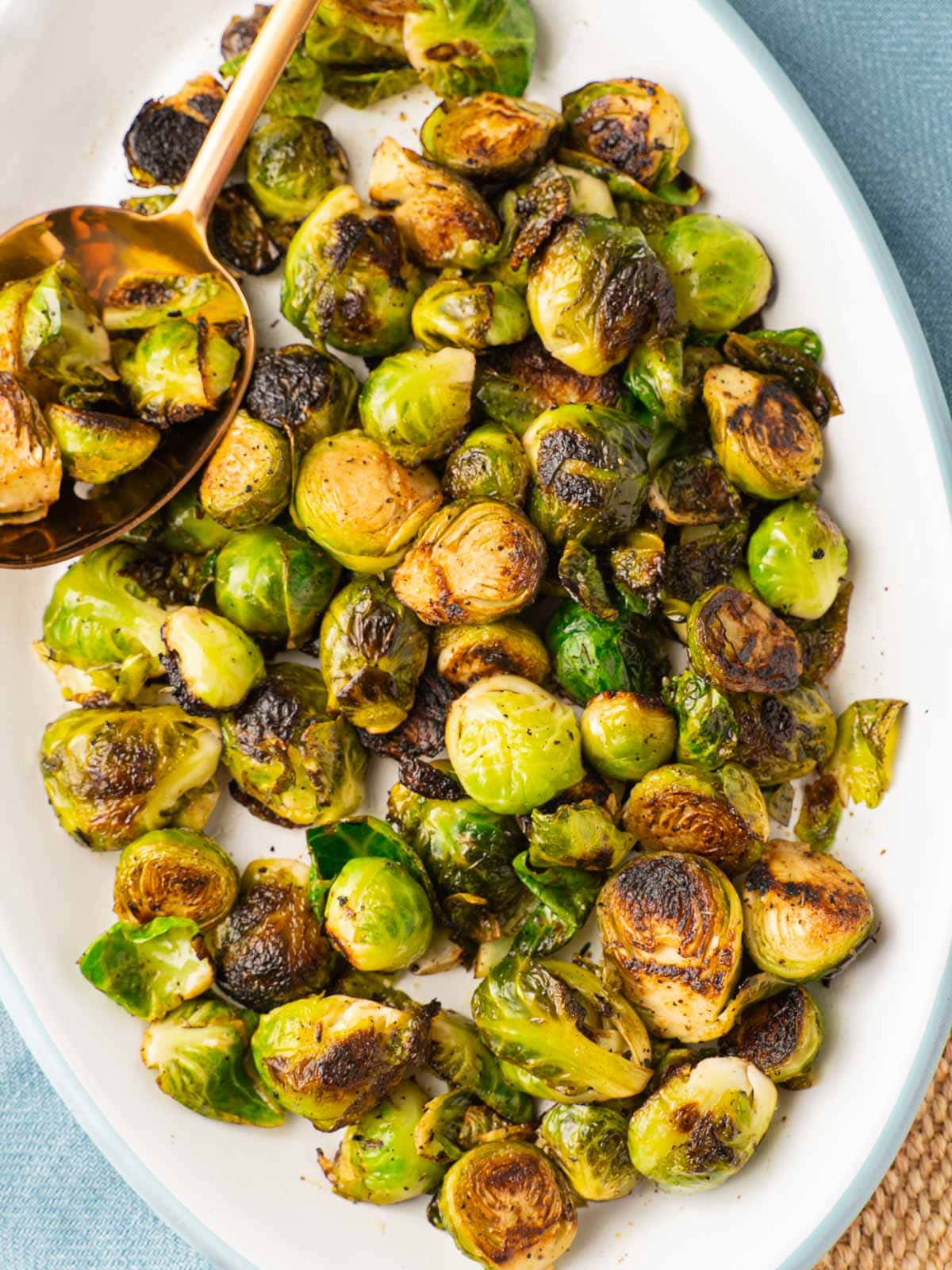 Marinated brussels sprouts on white platter.