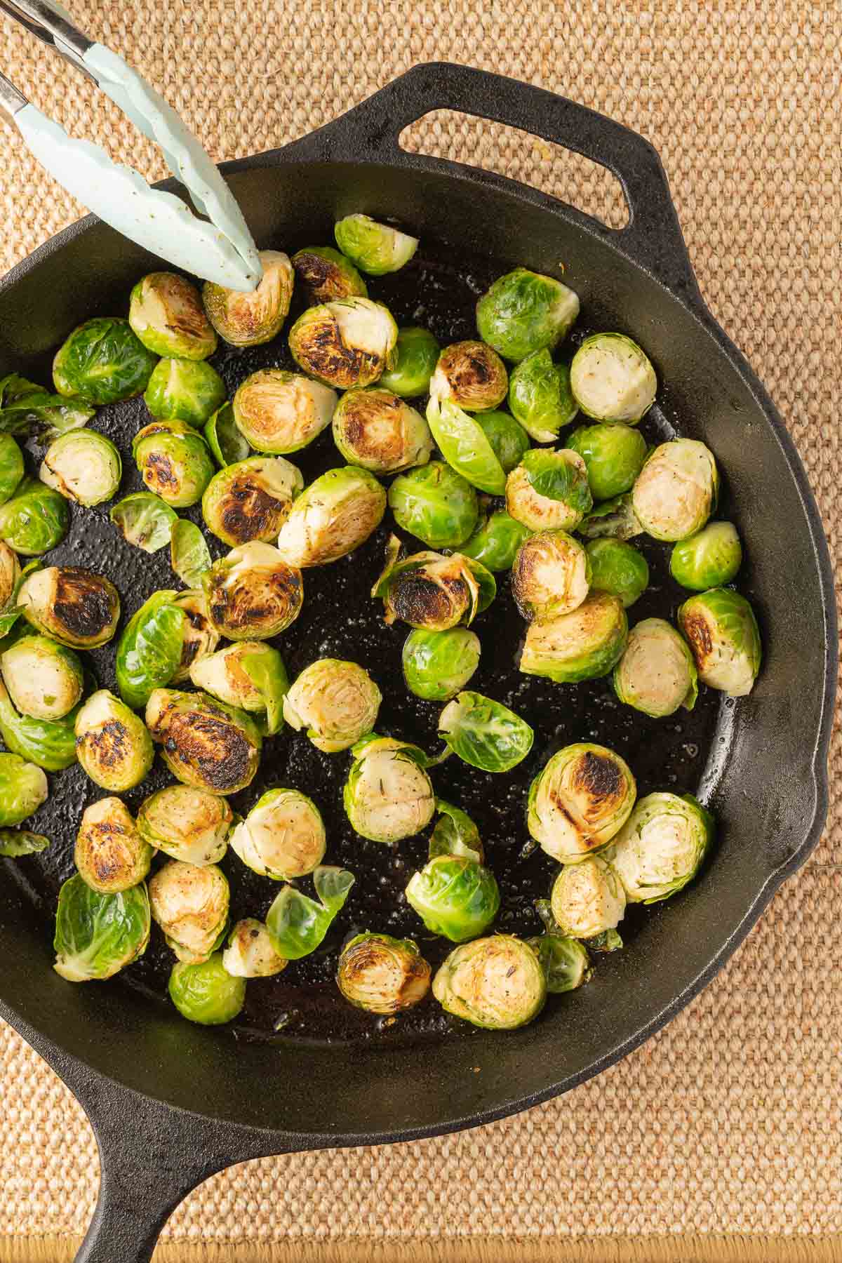 Browned brussel sprouts in cast iron skillet.
